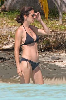 Дженнифер Коннелли в черном бикини на пляже фото #3